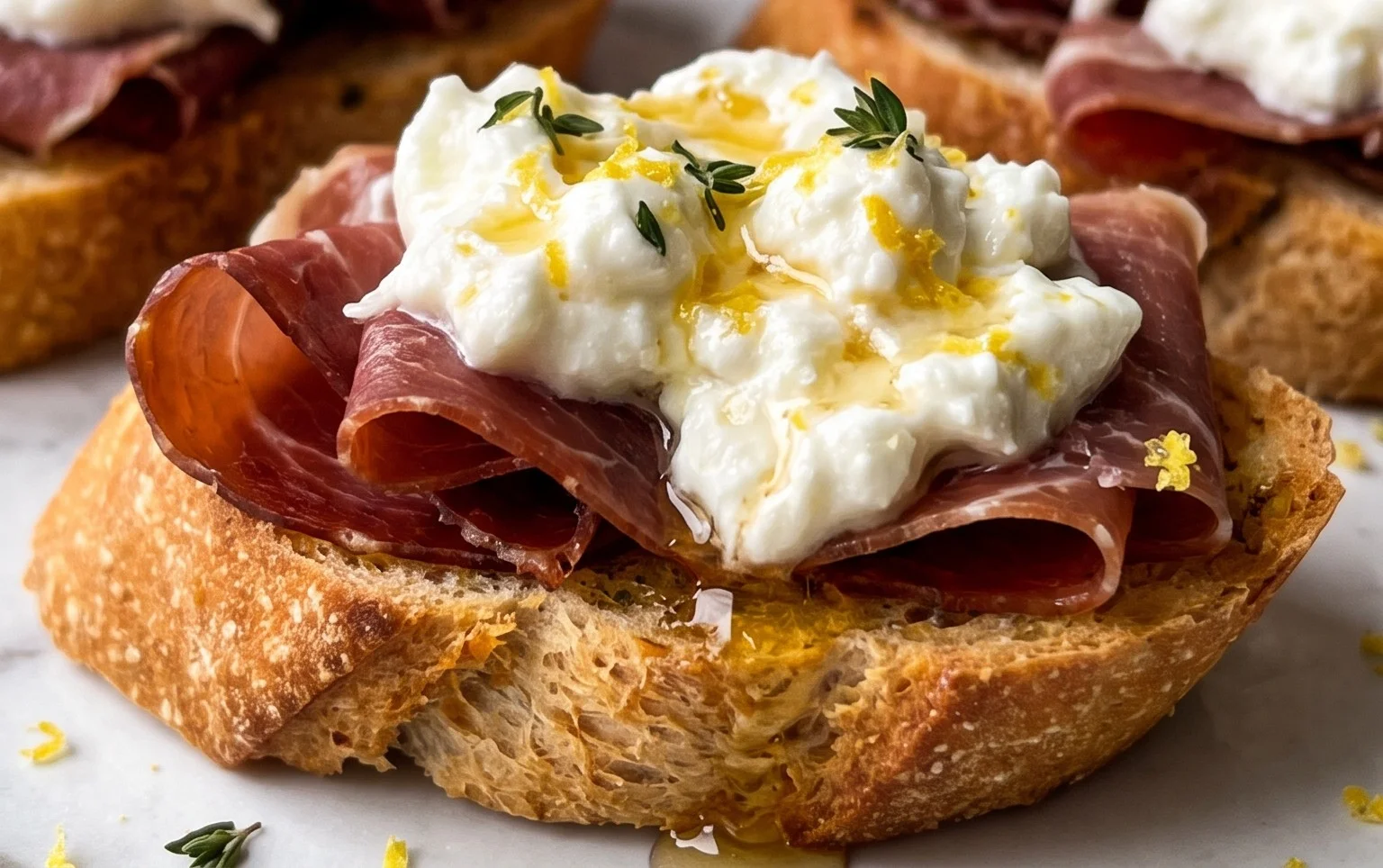 Beef Prosciutto Crostini with Burrata and Lemon Honey Drizzle